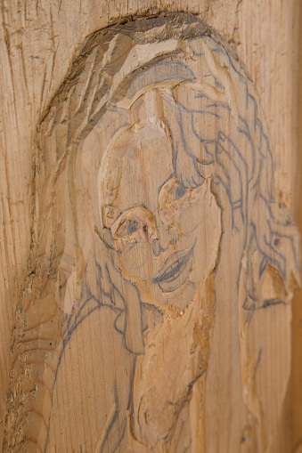 Girl portrait carved in wood