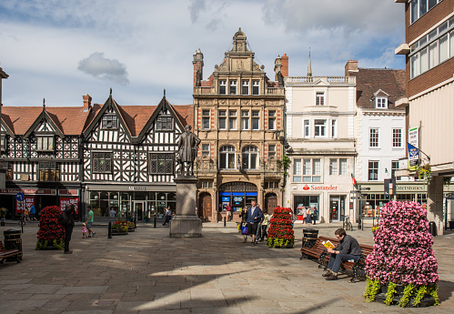 Shrewsbury, UK - July 19, 2015: shoppers stroll around the pedestrianised Old Market Square in the centre of Shrewsbury