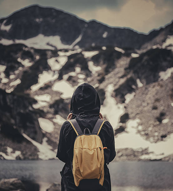 istock Traveler with backpack walking in mountains 484164784