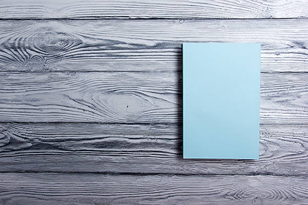 istock Blank book cover on textured wood background. Copy space 484165026