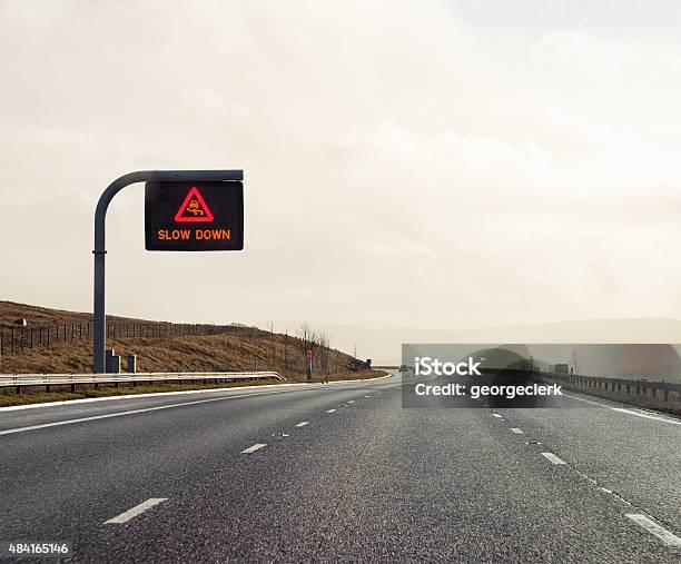 Slow Down Uk Motorway Warning Sign Stock Photo - Download Image Now - Multiple Lane Highway, Sign, UK