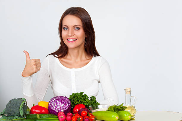 istock happy young woman with vegetables 484165179