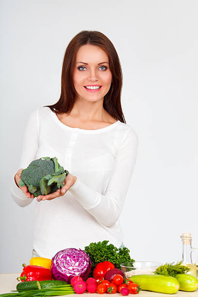 istock happy young woman with vegetables 484165183