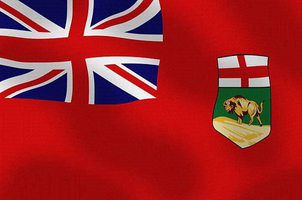 The provincial flag of Ontario, Canada waves on a flagpole against a clear blue sky.