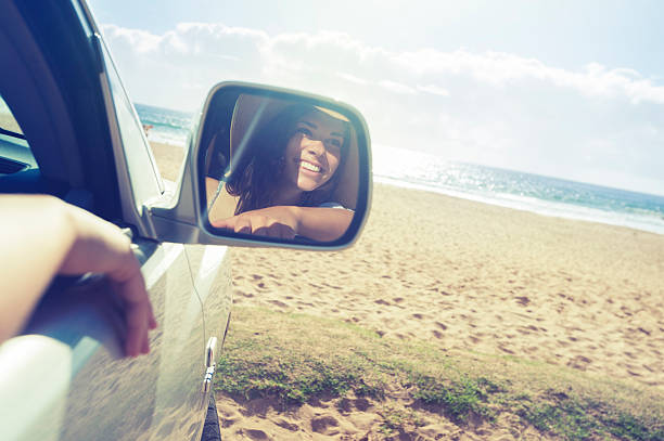 istock Woman looking at beach from a car 484168325