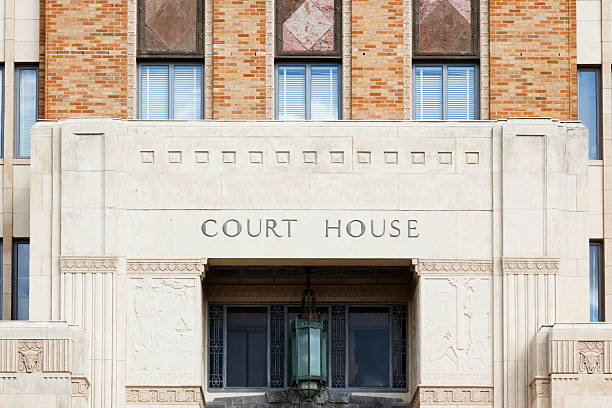 Front doors to an old courthouse in Texas, USA. Front doors to a courthouse in Beaumont, Texas, USA.  The old building is made of stone and bricks. The words "court house" are above the doors.  There is a blank space above the text, which is a perfect space for your copy.  beaumont tx stock pictures, royalty-free photos & images