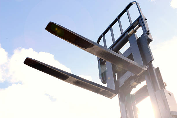 Forklift forks lens flare outdoor close up.