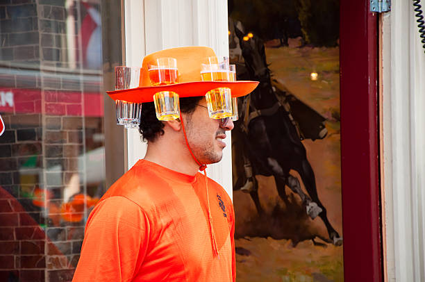 Local in orange on King's Day in Amsterdam. Amsterdam, the Netherlands - April 27, 2015: Local in orange on King's Day. wellen stock pictures, royalty-free photos & images
