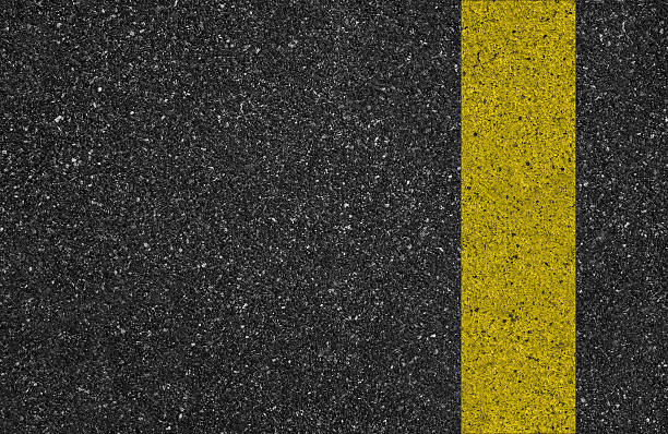 istock yellow line on the road texture 484170473