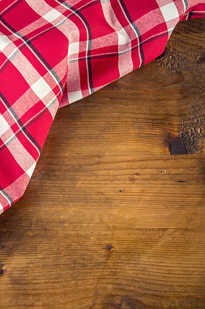 istock Top view of checkered napkin on wooden table. 484175132
