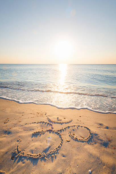 istock Om symbol in the sand by the ocean 484183874