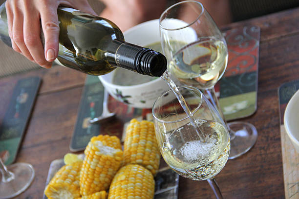 istock White wine is poured from the bottle into the glass 484188535