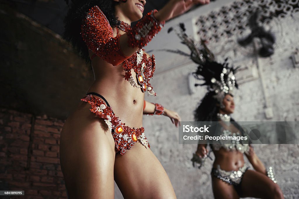 Beautiful bodies of Brazil Shot of two beautiful samba dancers performing during a carnival Activity Stock Photo