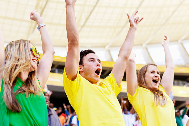 Mexican wave from group of excited Brazilian soccer fans A  group of extremely excited Brazilian soccer supporters raise their arms in a Mexican wave. doing the wave stock pictures, royalty-free photos & images