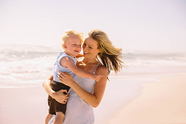 istock Boy and mother laughing on beach 484190807