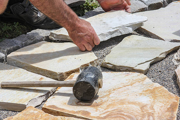 Paver with marble plates Worker ist paving a place in the garden. pedestrian walkway stock pictures, royalty-free photos & images