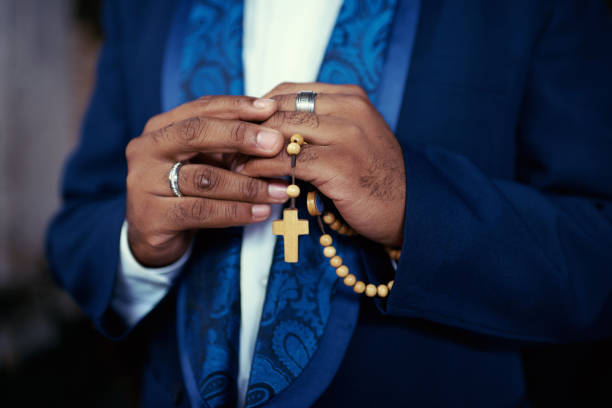 Cropped shot of an ethnic man holding his rosary beads