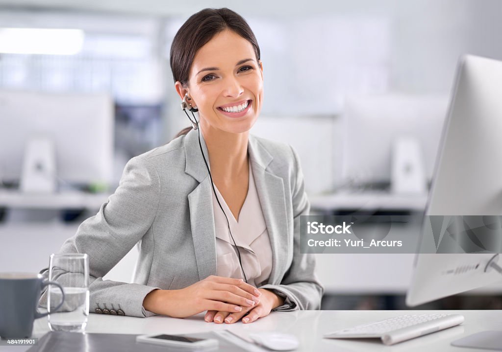 I find new satisfaction in my work each day! Shot of an attractive businesswoman sitting at her desk in an officehttp://195.154.178.81/DATA/i_collage/pi/shoots/783151.jpg Secretary Stock Photo