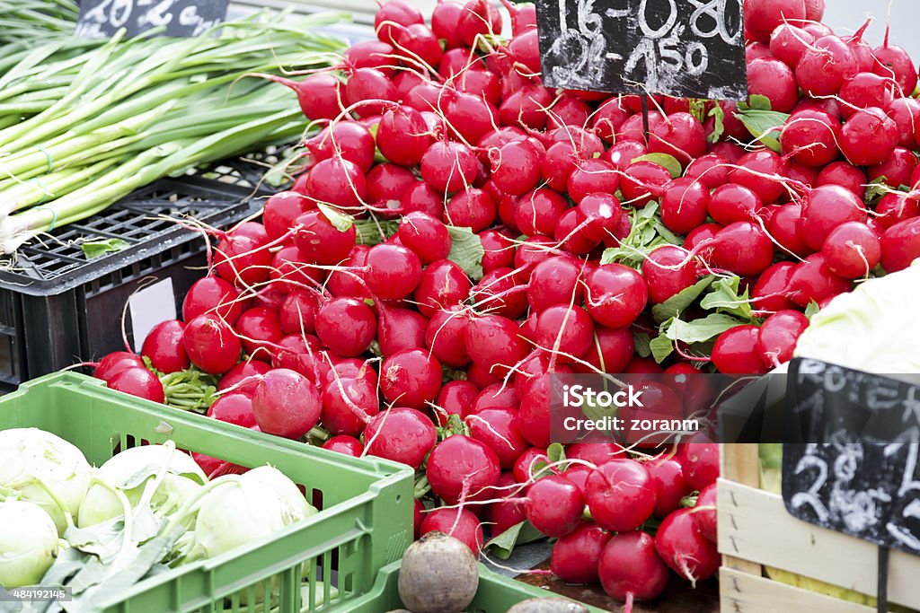 Red radish Fresh red radish on market stall Agricultural Fair Stock Photo