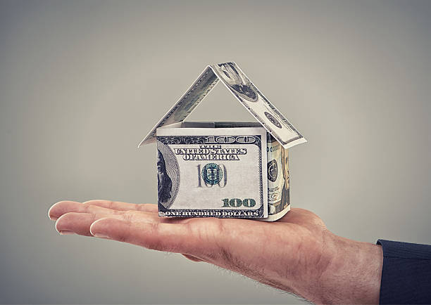 He can buy his dream home now Close up conceptual shot of a man holding money that has been made to look like a househttp://195.154.178.81/DATA/i_collage/pi/shoots/783303.jpg money house stock pictures, royalty-free photos & images