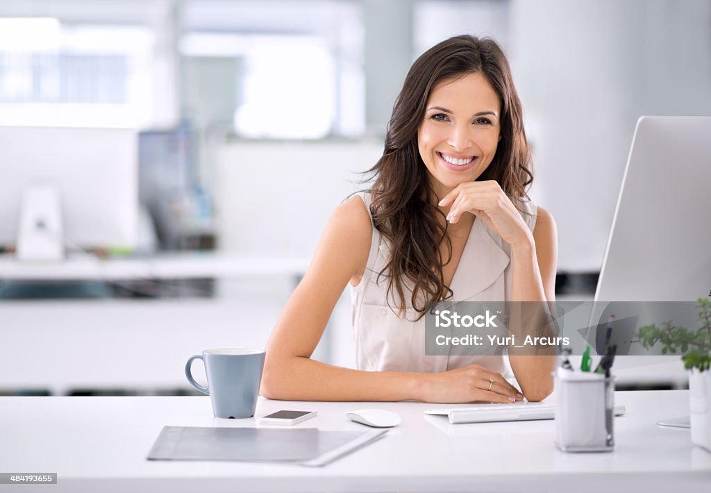 She's achieved her corporate dreams Shot of an attractive businesswoman sitting at her desk in an officehttp://195.154.178.81/DATA/i_collage/pi/shoots/783151.jpg Desk Stock Photo