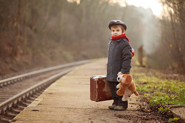 istock Little boy with suitcase and teddy toy 484195371