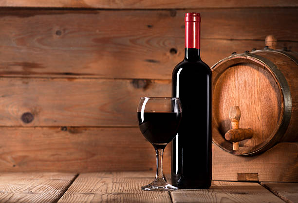 istock Red wine on wooden background 484195498