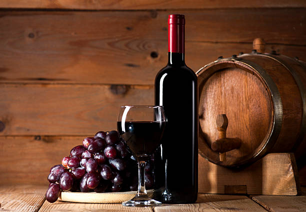 istock Red wine on wooden background 484195502