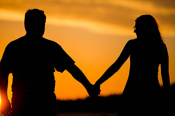 istock Young couple walk on the sunset 484198554