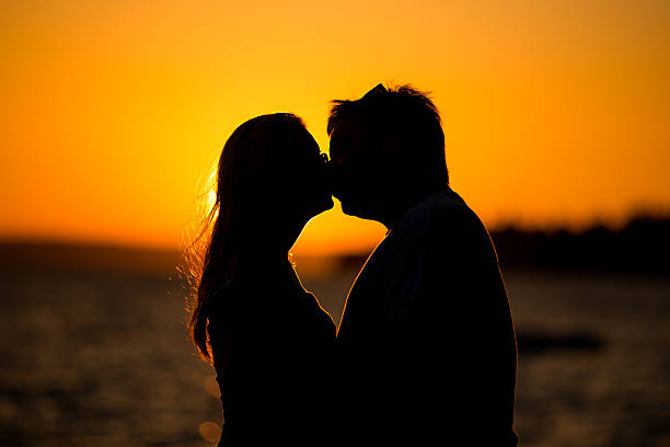 istock Young couple kissing on the beach sunset 484198556