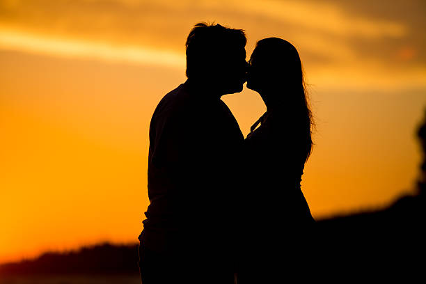 istock Young couple kissing on the beach sunset 484198572