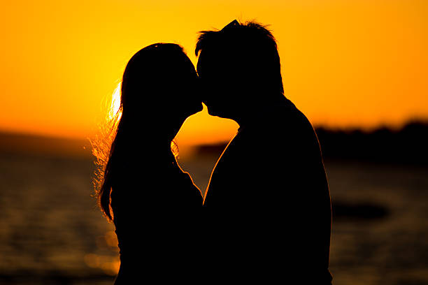 istock Young couple kissing on the beach sunset 484198576
