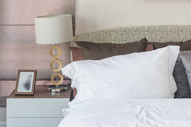 istock white pillow in modern bedroom with white lamp on table 484198734