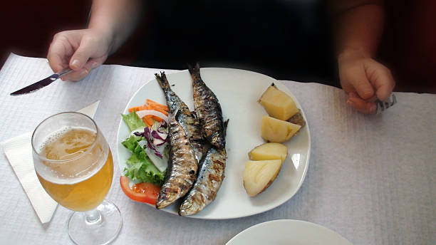 istock Woman's Hand Holding Knife And Fork Ready To Eat Seafood 484199532
