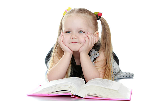 istock Girl reading a book lying on the floor 484200462
