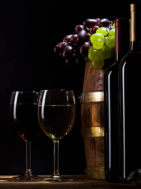 istock Red and white wine on wooden background 484202754