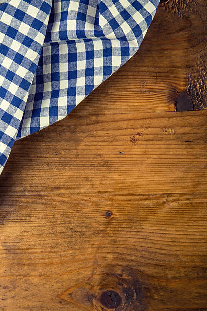 istock Top view of checkered napkin on wooden table. 484203014