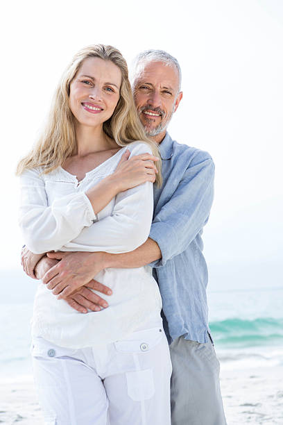 istock Happy couple hugging each other and looking at camera 484203728