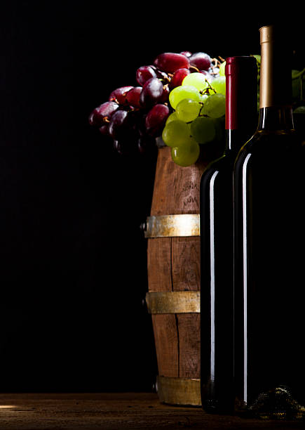 istock Red and white wine on wooden background 484215492