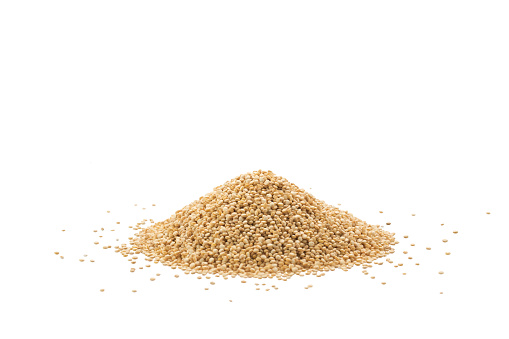 Pile of raw quinoa seeds isolated on a white background
