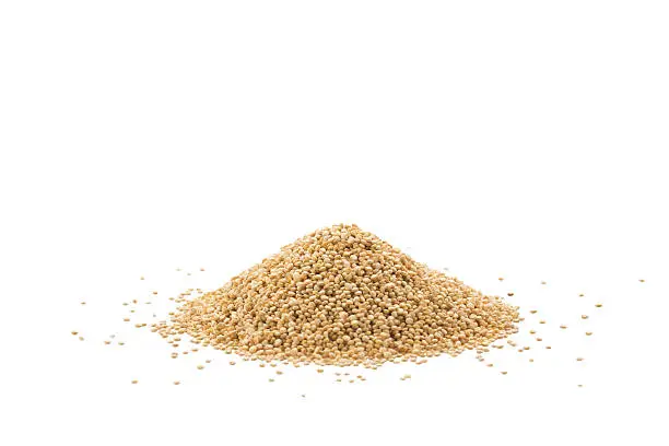 Pile of raw quinoa seeds isolated on a white background