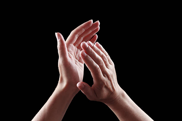 istock beautiful female hands isolated on black background applause 484218408