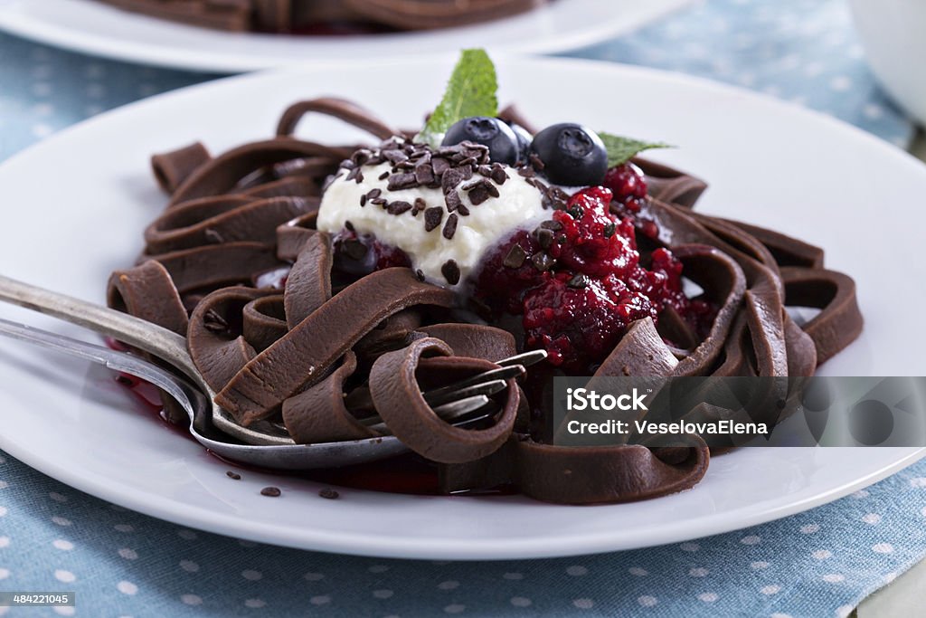 Chocolate pasta Chocolate pasta with raspberry sauce, whipped cream and fresh berries Chocolate Easter Egg Stock Photo