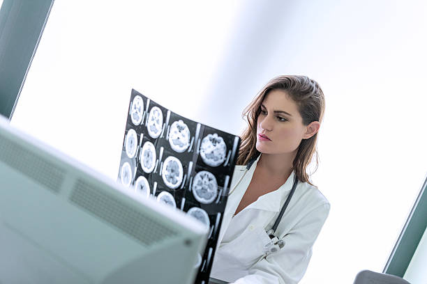istock Doctor examining MRI scan 484221826