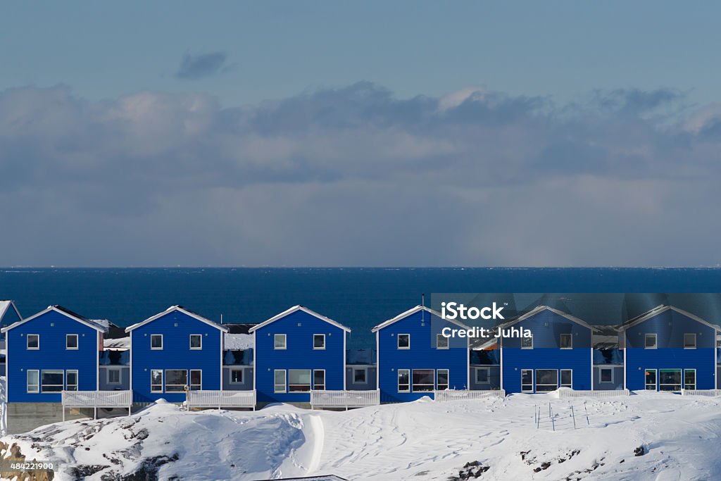 Horizon in Sisimiut Row of blue houses in the village of Sisimiut (Greenland) in winter 2015 Stock Photo