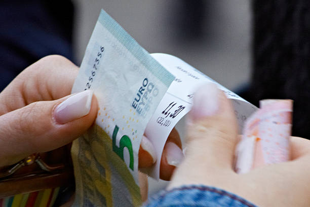 istock Hand holding Euro bills and receipt 484221997
