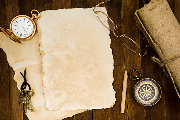 istock Old paper, compass, pocket watch on wooden background 484222366