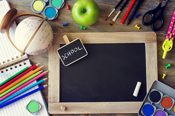 Stationery with chalk board and terrestrial globe. back to schoo Stationery with chalk board, terrestrial globe, pencils and paints back to school and learning concept copy space background back to schoo stock pictures, royalty-free photos & images