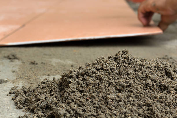 istock Plasterer is tiling at home, tile floor adhesive renovation 484225036