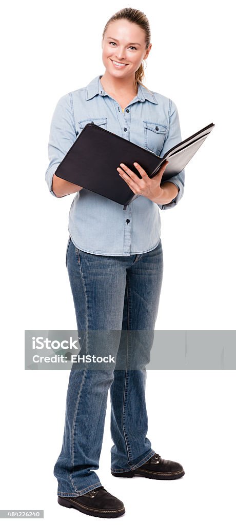 Young Woman with Notebook on White Twenty-something blonde woman in blue denim shirt and jeans standing with notebook portfolio, isolated on white background 20-29 Years Stock Photo